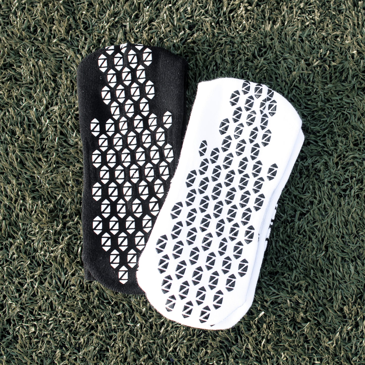 Black and White Preza Grip socks on turf.