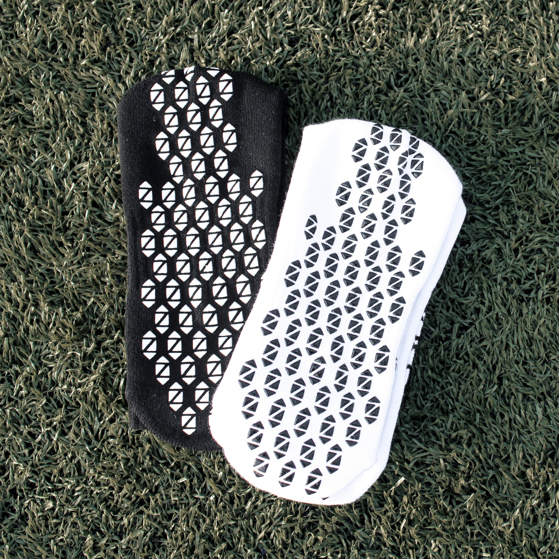 Black and White Preza Grip socks on turf.